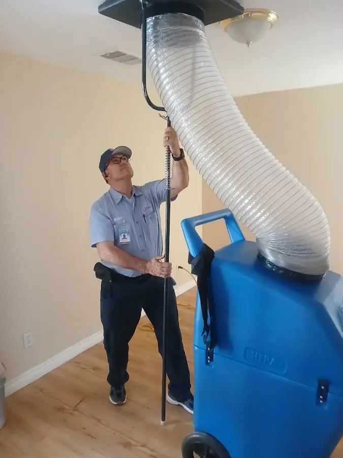 Furnace Tune-Up technician using HEPA equipment in Key Largo