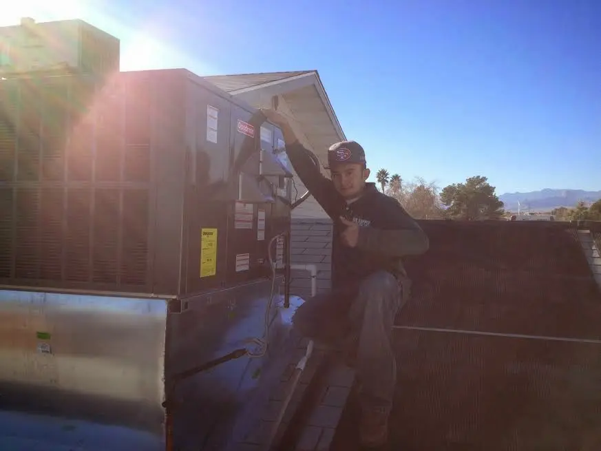 HVAC technician performing AC Tune-Up on a rooftop unit in Key Largo